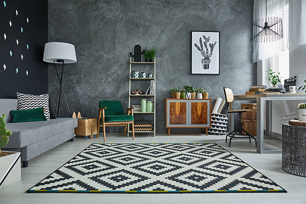 grey room with pattern carpet and wooden furniture